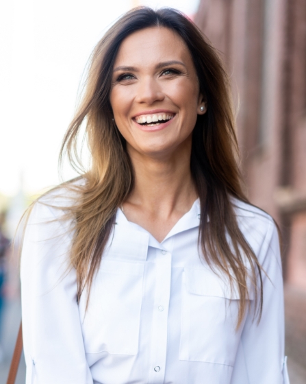 Woman wearing white shirt smiling